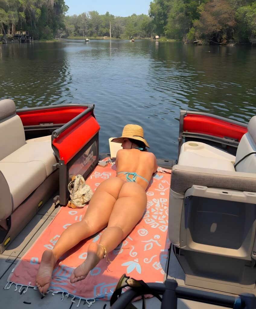 Violet Moore sunbathing on a boat
